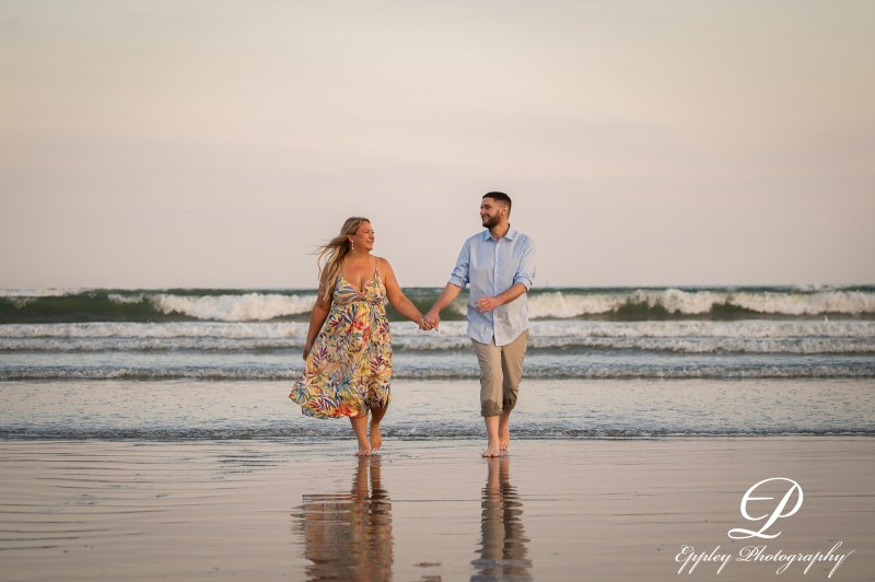 Wayne and Christy holding hands while wading in the waves