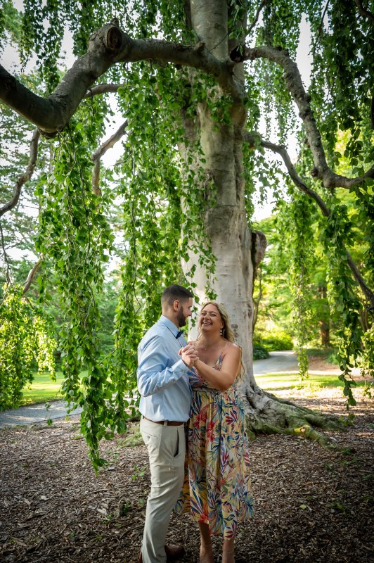 Wayne and Christy beneath a tall tree