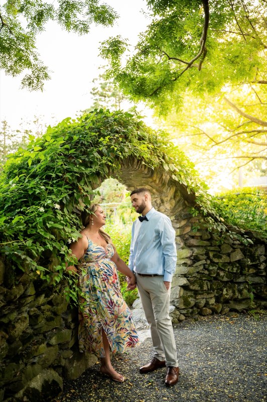 Wayne and Christy beneath an ivy-covered arch