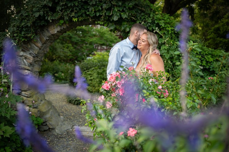Wayne and Christy kissing among purple flowers